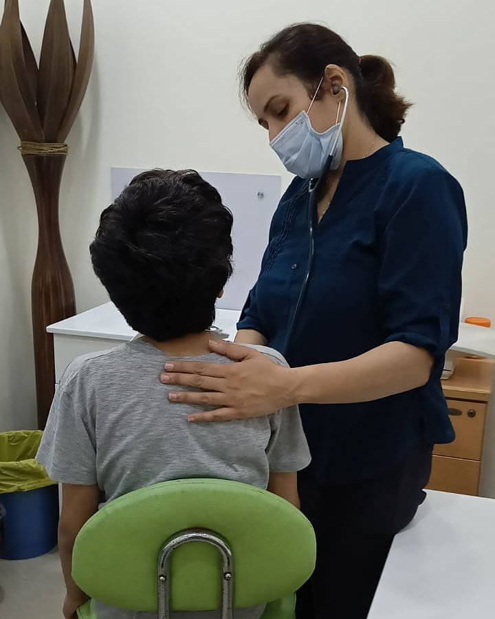 Dr. Preeti Chadha examining a child with a stethoscope